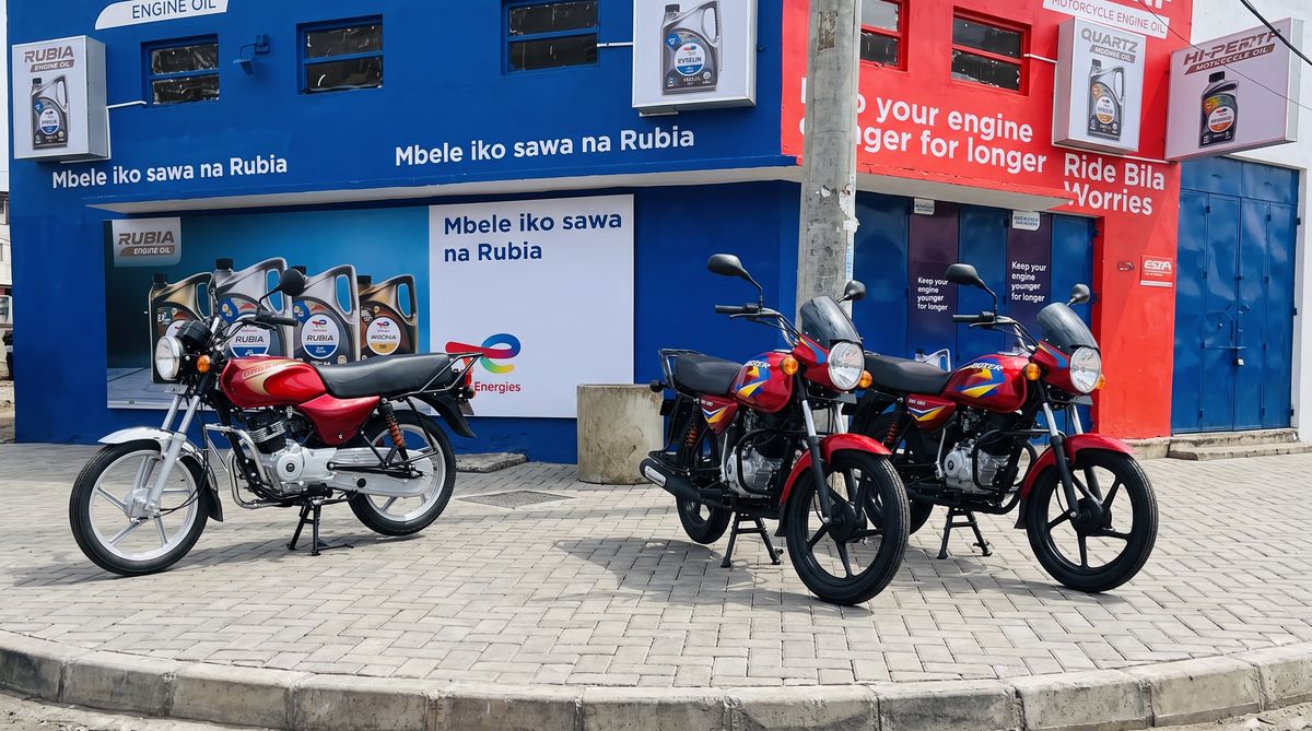 Generated image: three red Bajaj Boxer motorcycles parked outside a shop.